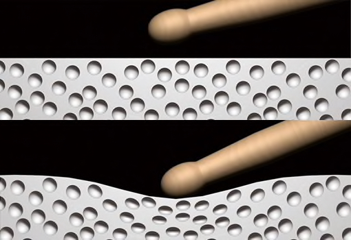 Closeup of drumstick striking and compressing foam.