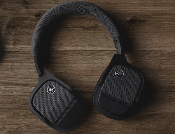 Wireless Yamaha headphones on desk.