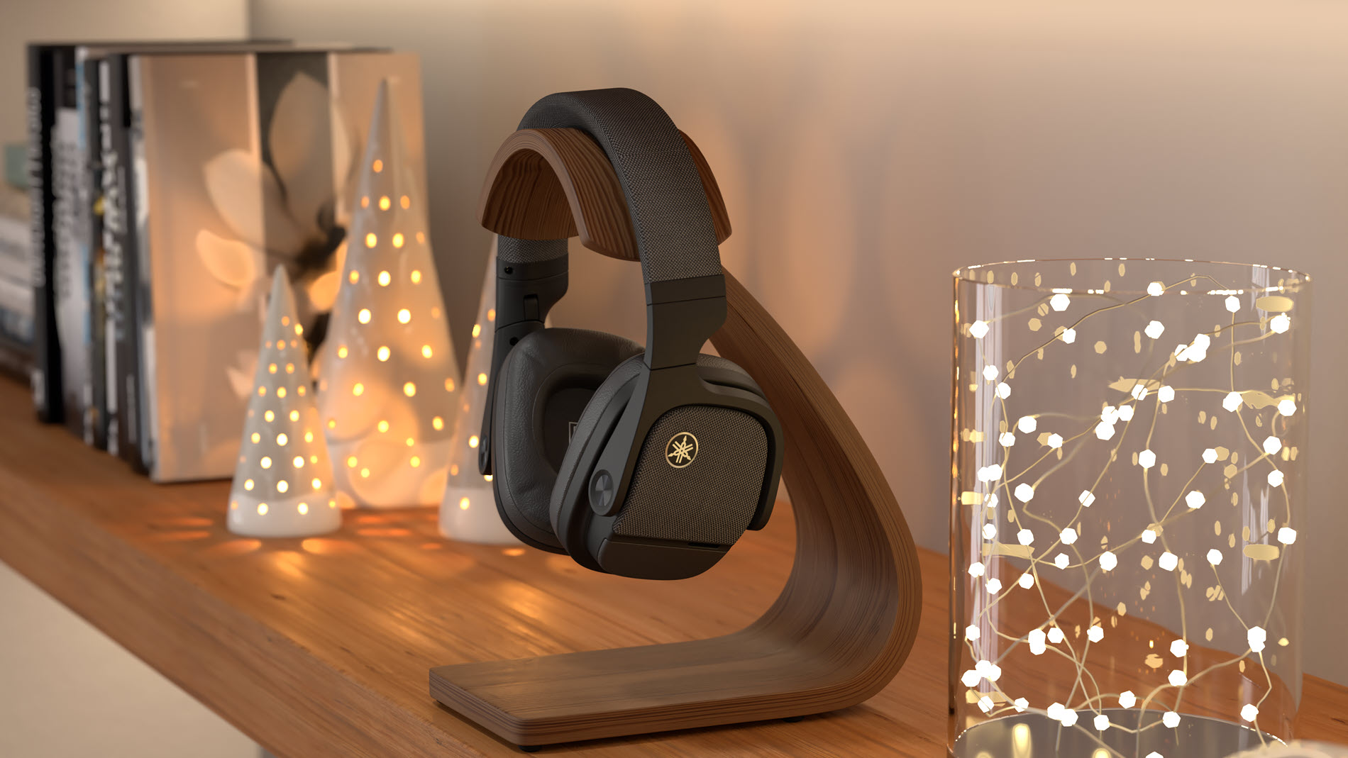 Wireless headphones on a modern wood stand on a bookshelf surrounded by stylish holiday decorations.