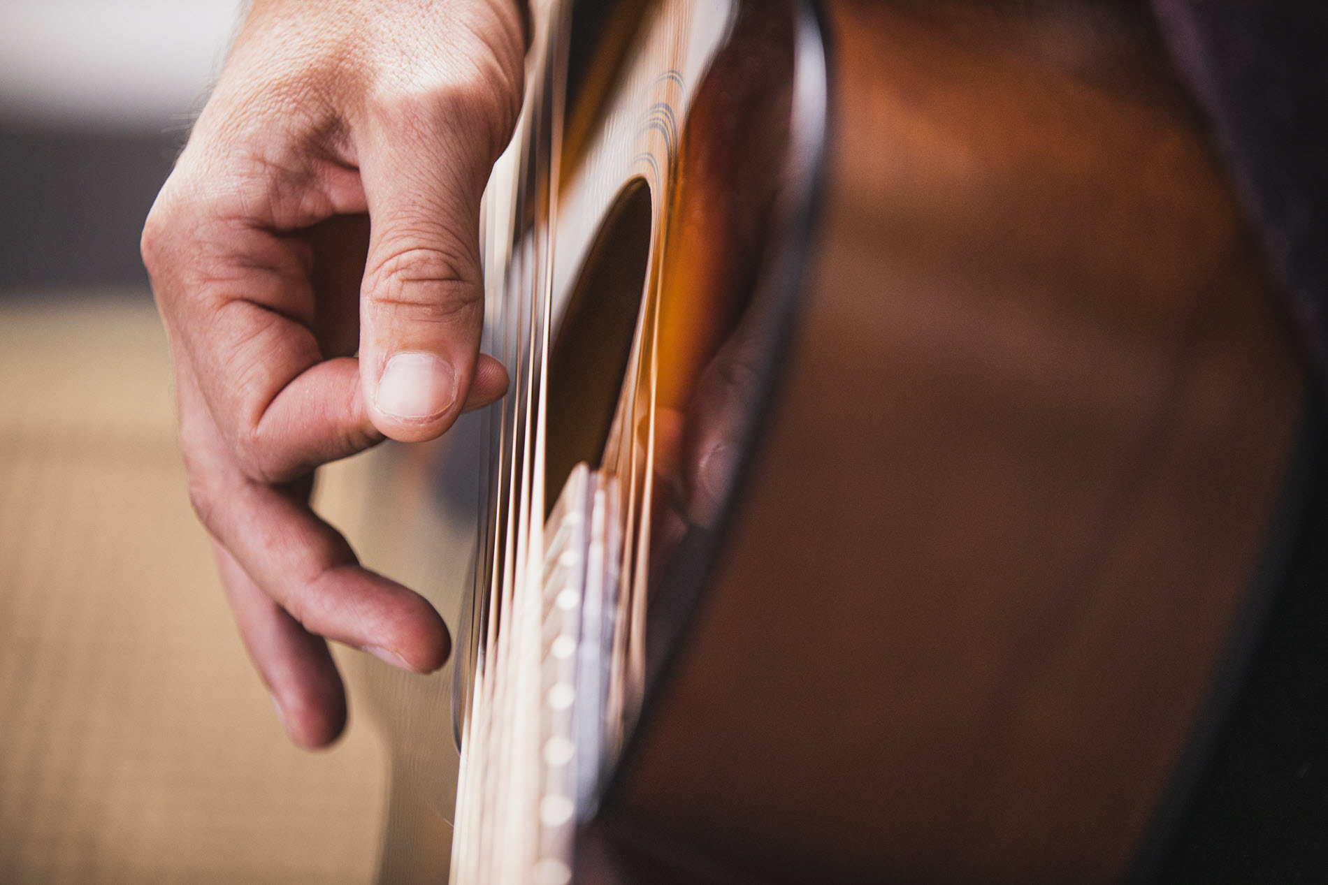 Closeup of someone playing an acoustic guitar.