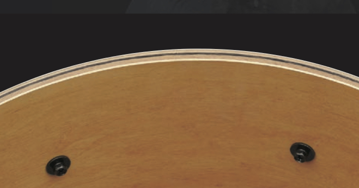 Closeup of inside edge of a drum shell showing the layers of wood and other materials that make up the shell.
