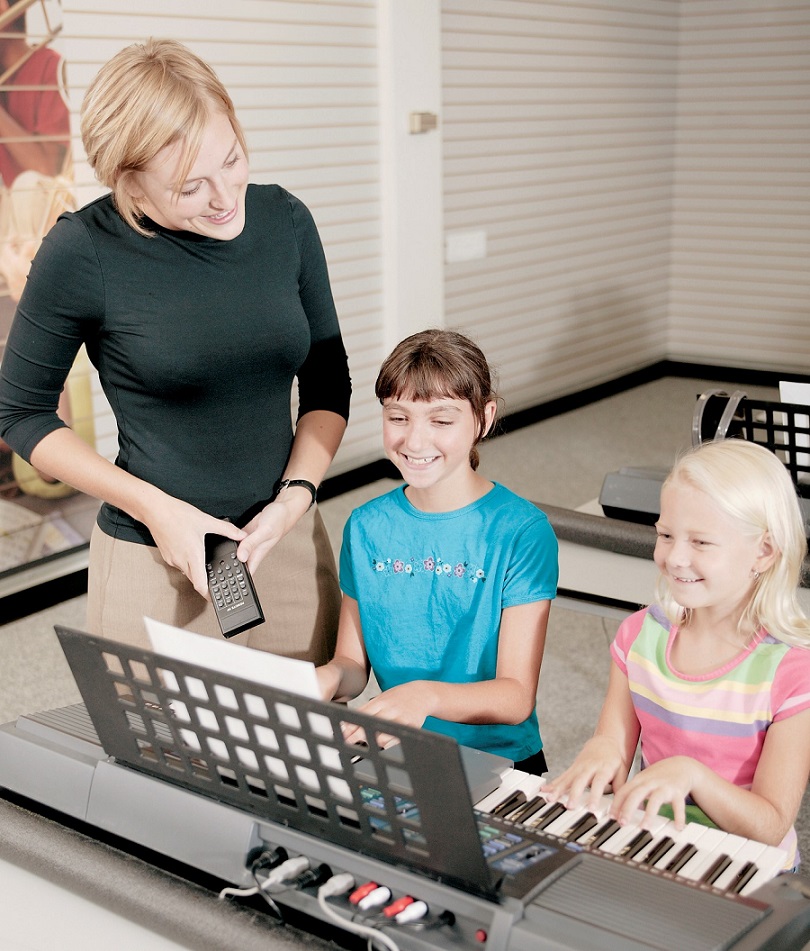 piano teacher with two female students