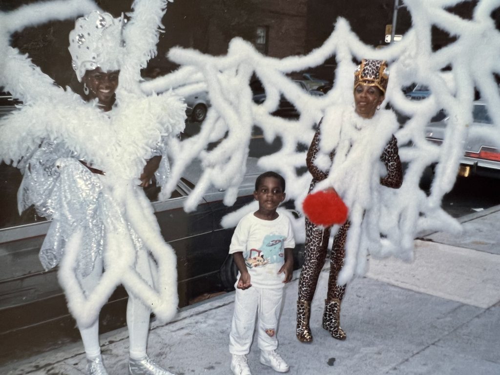 Young boy with Carnival dancers.