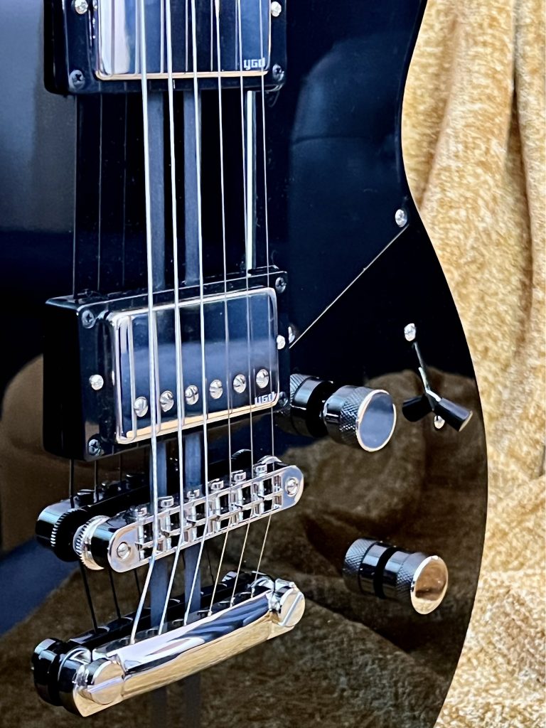 Closeup of the body of an electric guitar.