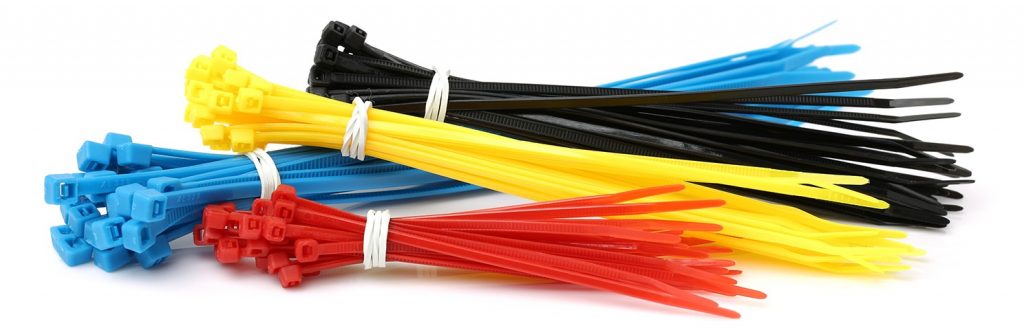 Different colors and sizes of cable ties bundle as groups with like sized ties.