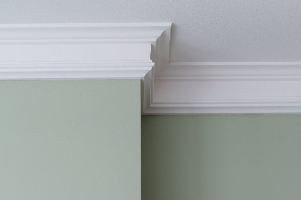 Closeup of crown molding along the top of a wall.
