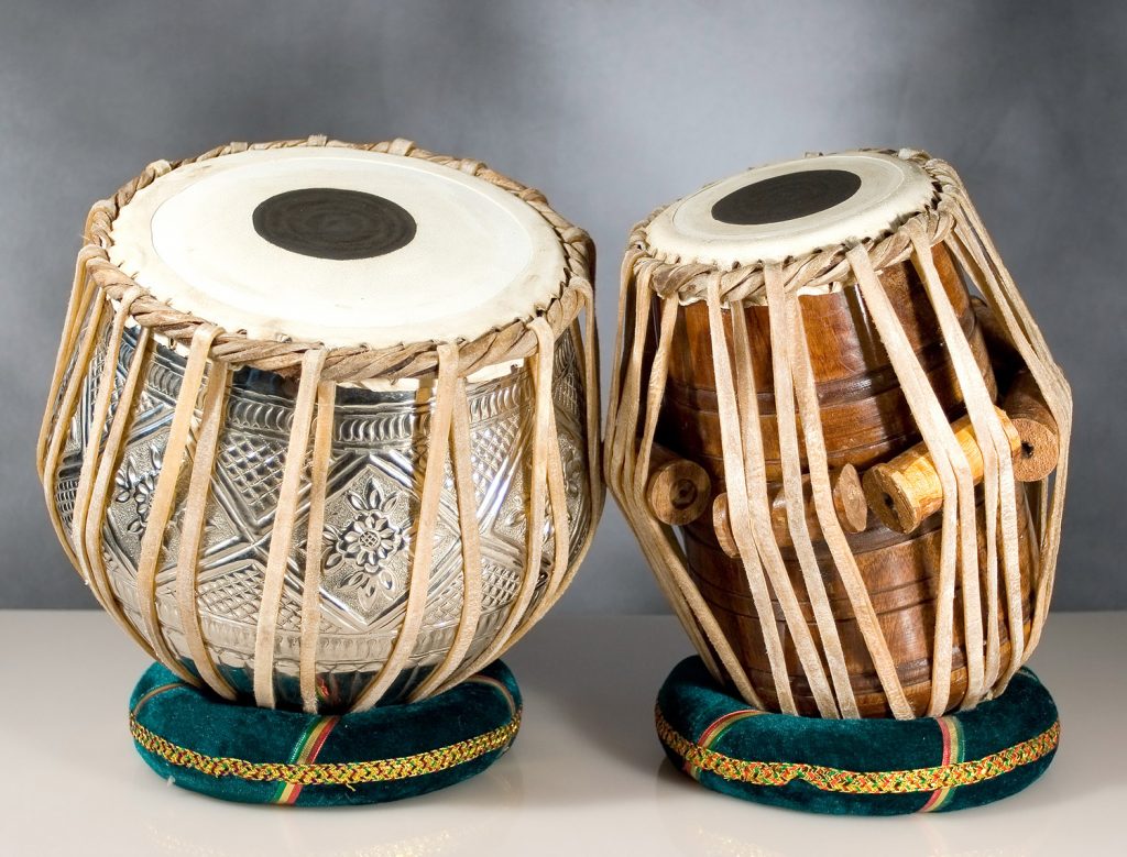 Two small wooden drums with raffia wrapping.