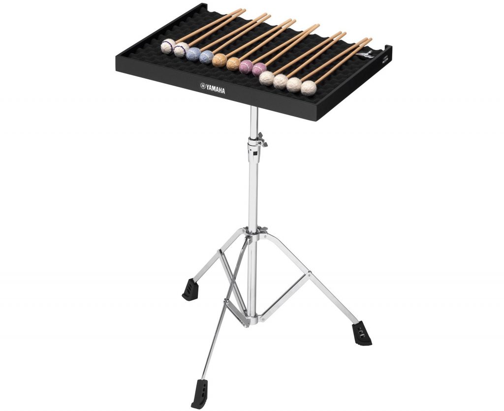 Metal stand with tripod style feet holding a tray of drum mallets.