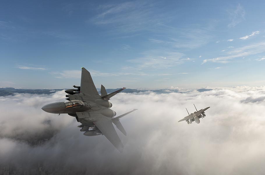 Modern fighter jets zipping across the sky.