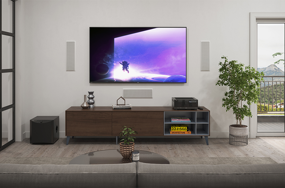 Modern living room with large flat screen and audio equipment.