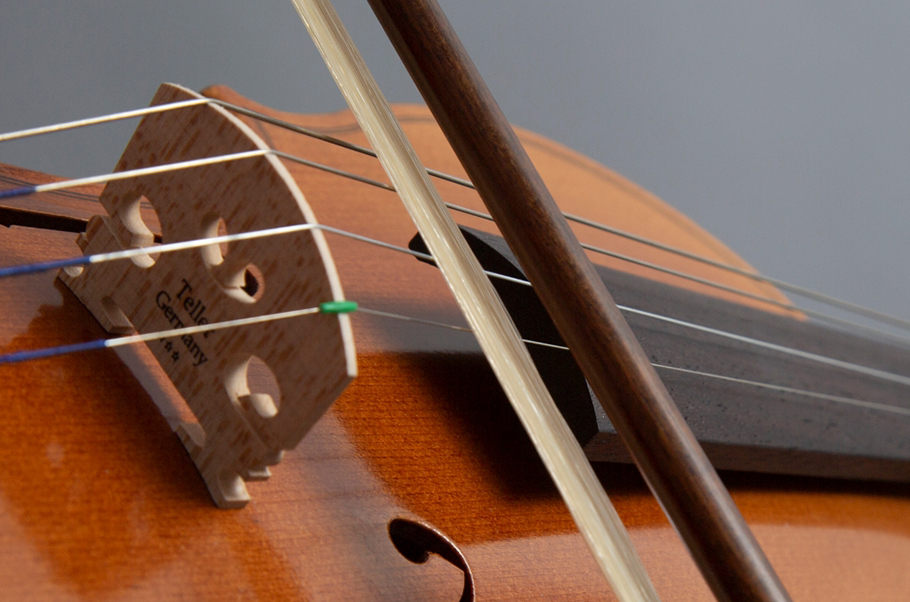 Closeup of a violin being bowed.