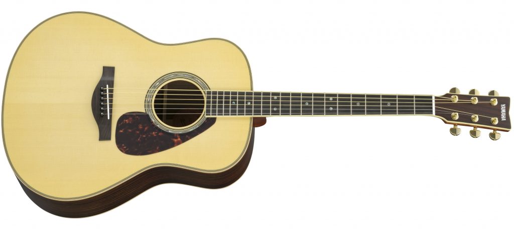 Acoustic guitar with light color face and darker sides on body.