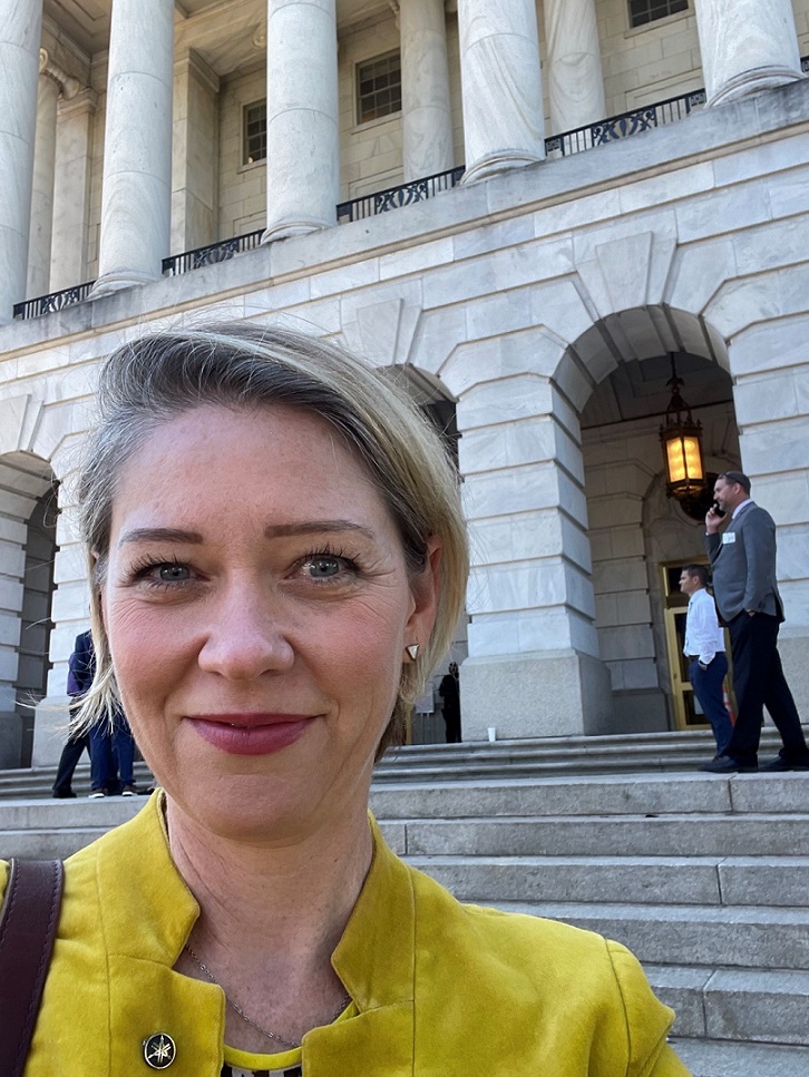 Heather Mansell standing at the steps of the Capitol