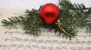 round ornament sitting on top of sheet music