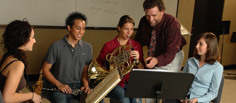music teacher with four music students
