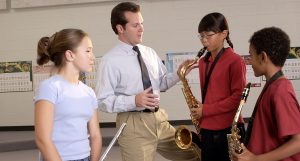 music teacher with three winds students