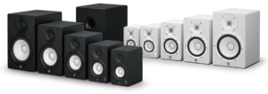 Five speakers in black and in white, plus a subwoofer in black.