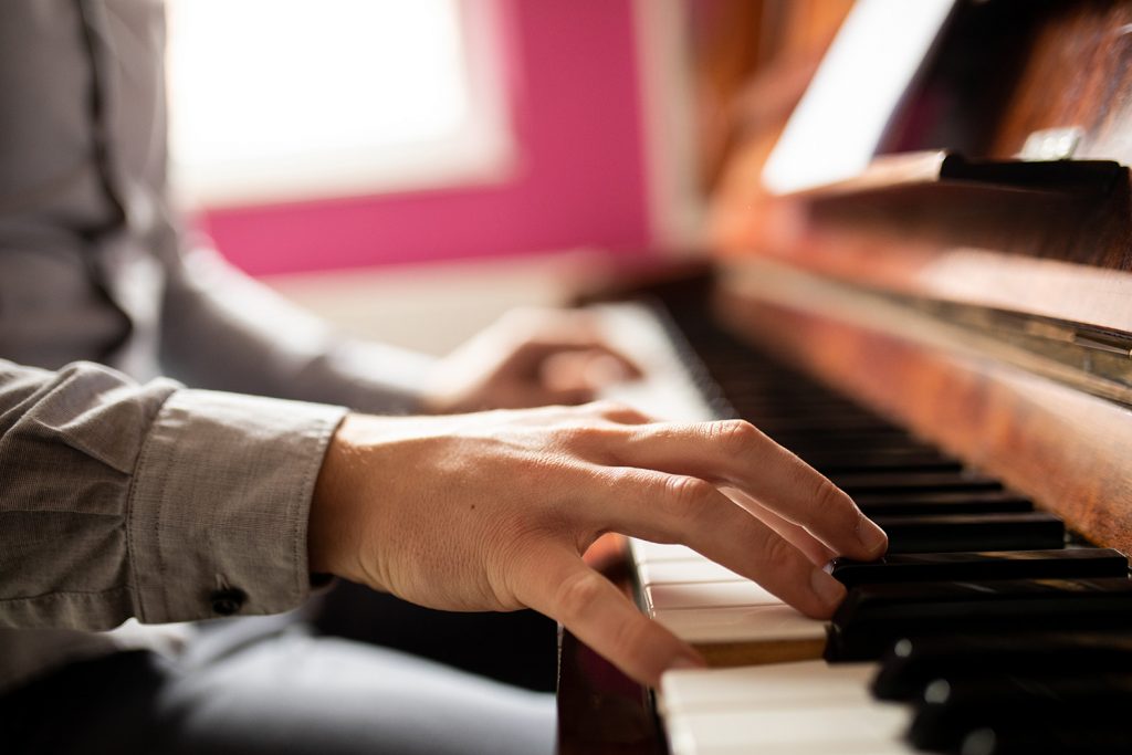 Closeup of hands playing piano.