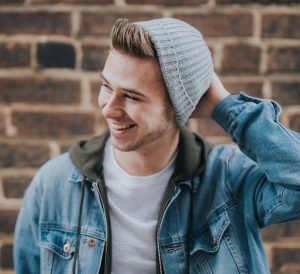 happy male student with beanie on
