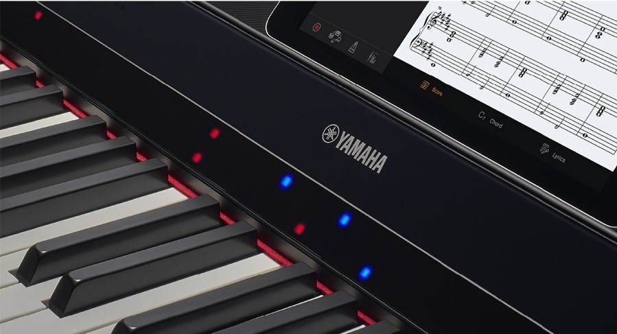 Closeup of an electronic keyboard with lights above keys.