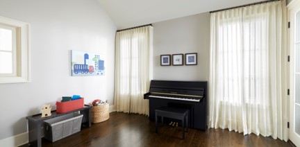 Upright piano in kid's room.