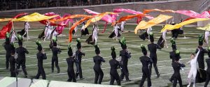 Visual ensemble members rush the field bringing color to the conclusion of the Reagan band’s 2023 “In Plain Sight” show at the Texas Marching Classic.