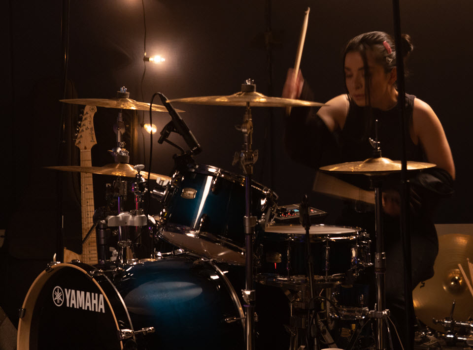 Woman playing drums.