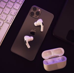 computer, cell phone and earbuds