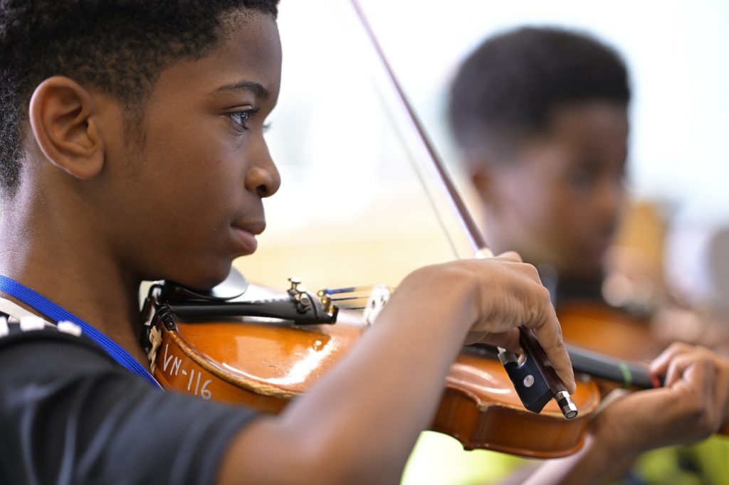 two students playing violin