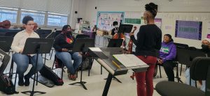 students learning from musician Brooke Alford