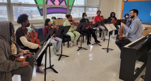 strings students learning from a member of the Louiville Orchestra