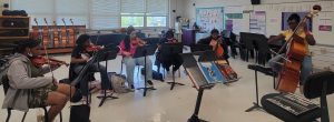strings students playing instruments