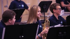 students smiling during band rehearsal
