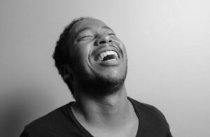 man laughing with head thrown back