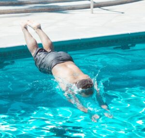 man diving into pool