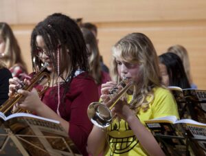 two female students playing trumpet