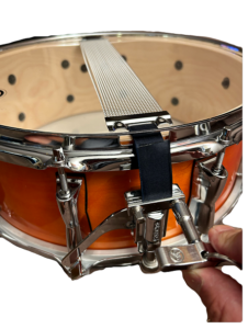 adjusting snares on snare drum