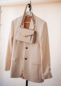 jacket, shirt and matching purse hanging on a hanger