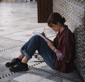 introverted female sitting alone in a school hallway