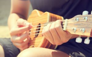 closeup of someone playing the ukulele