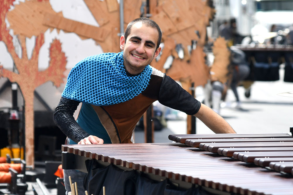 Smiling man next to marimba.