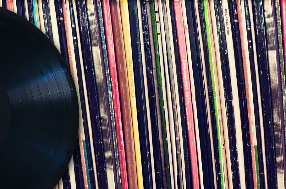 Row of vinyl albums on a shelf.