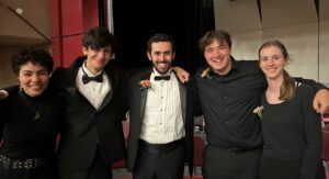 male music educator with four students in concert black