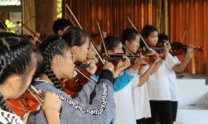 group of Thai students playing violins 