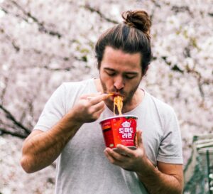 man eating instant ramen