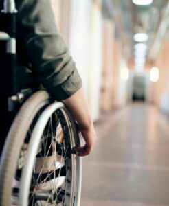 viewpoint of someone in a wheelchair looking down a school hallway