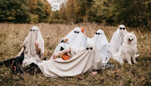 family dressed as ghosts in the forest