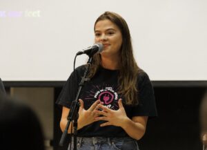 student leader speaking at microphone