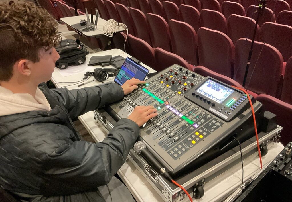 Abington School District student working on sound equipment