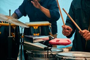 two percussion students holding drumsticks